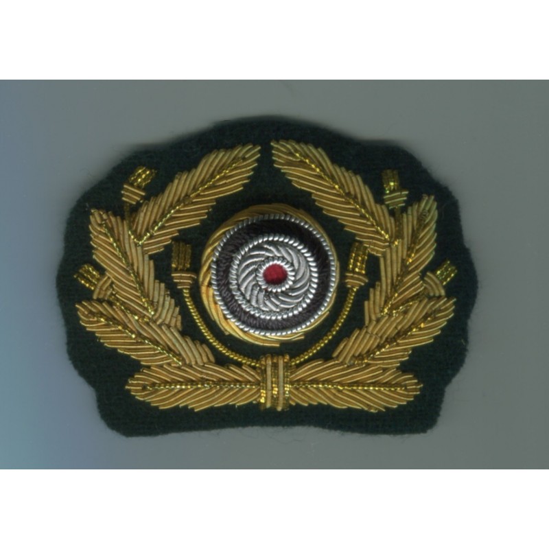 Bullion oakleaf wreath and cockade for visor caps. Made with gold bullion wire on a dark green backing